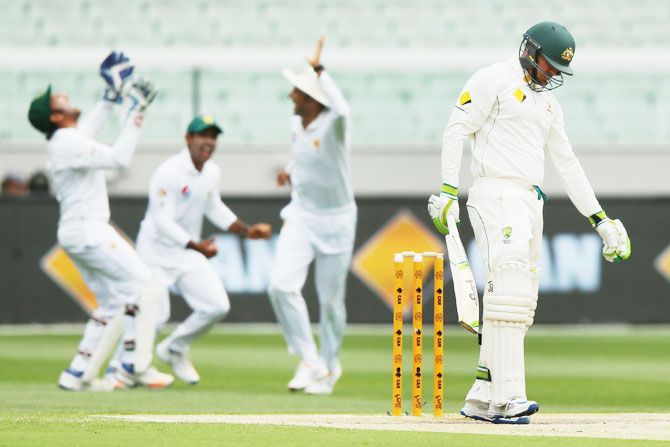Australia's Usman Khawaja reacts after being caught out for 98