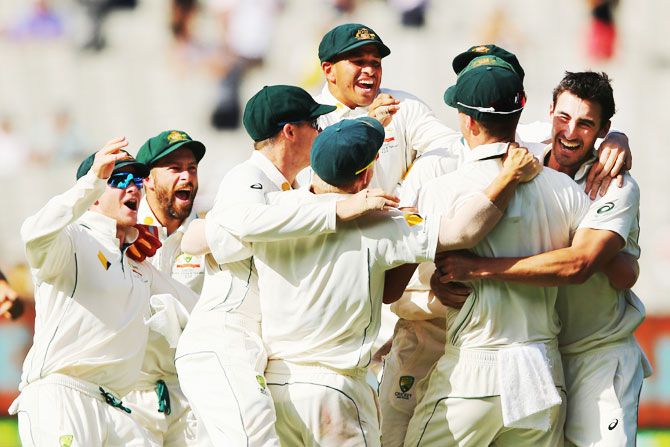 Australia's Mitchell Starc (right) celebrates with teammates after claiming the wicket of Pakistan's Yasir Shah to win the Boxing Day Test match on Day 5 at Melbourne Cricket Ground on Friday