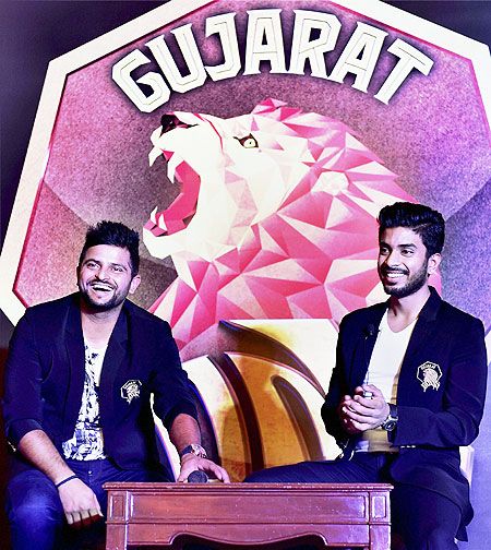Suresh Raina newly appointed captain of the Gujarat Lions, with team owner Keshav Bansal during the unveiling of the the team logo in New Delhi on Tuesday