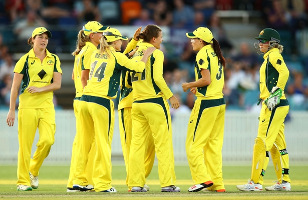 Australian women celebrate taking an Indian wicket 