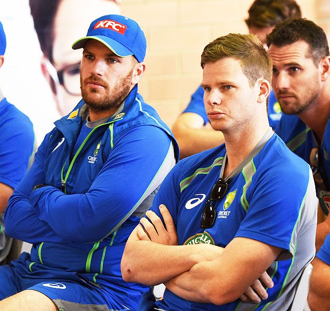 Australia's Aaron Finch and Steven Smith look on during a training session