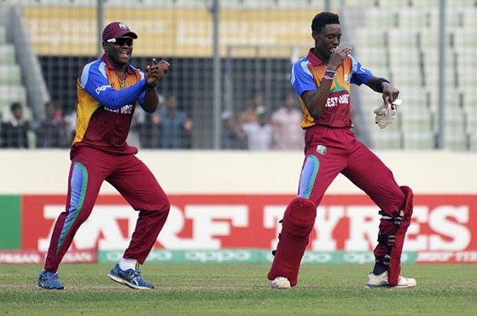 Shamar Springer of West Indies celebrates with teammate Gidron Pope 