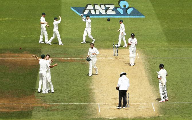 Australia's Mitch Marsh celebrates with teammates after claiming the wicket of New Zealand's Trent Boult to register victory on Day 4 of the 1st Test match at Basin Reserve in Wellington on Monday