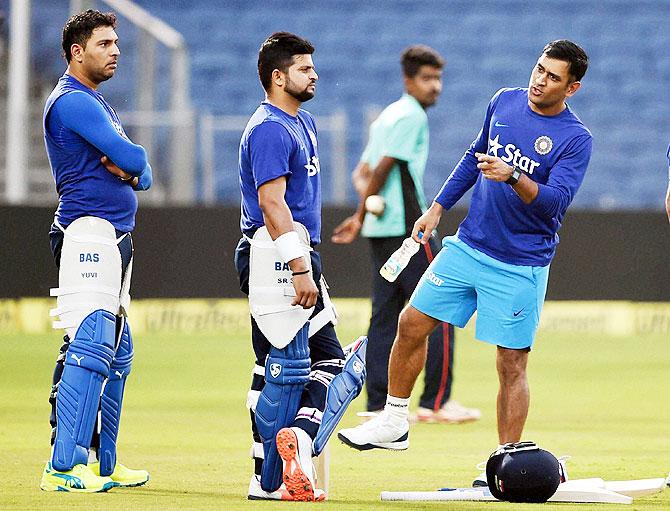 Indian team captain Mahendra Singh Dhoni along with teammates Yuvraj Singh and Suresh Raina during a practice session 