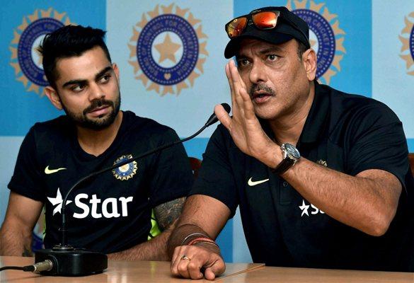 Virat Kohli (left) looks on as Indian Team Director Ravi Shastri addresses the media 