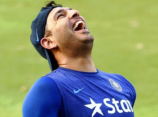 Yuvraj Singh laughs during a team training session