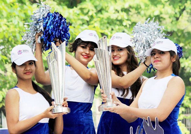 Models display the ICC T20 World Cup Trophy during an event for its public viewing in Nagpur on Saturday