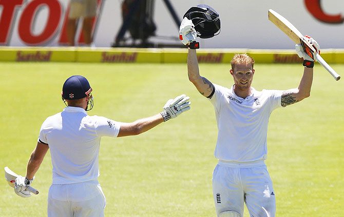 England's Ben Stokes celebrates scoring a double century with Jonny Bairstow during the second cricket Test match against South Africa in Cape Town on Sunday
