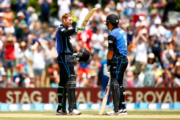 Martin Guptill of New Zealand (left) celebrates his century with Ross Taylor 