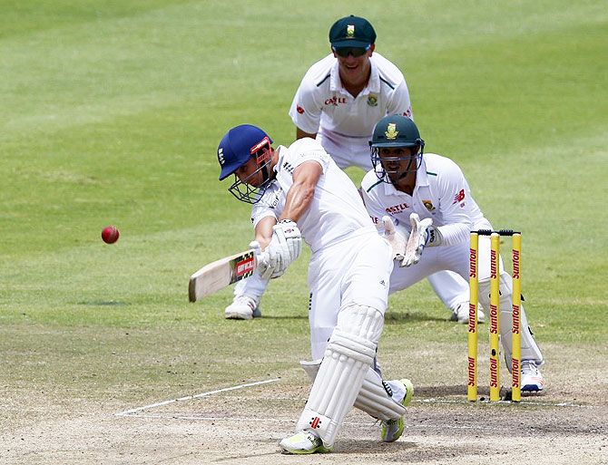 England's James Taylor plays a shot as South Africa's Quinton de Kock and Chris Morris (back) look on during Day 5 of the second cricket Test match in Cape Town on Wednesday