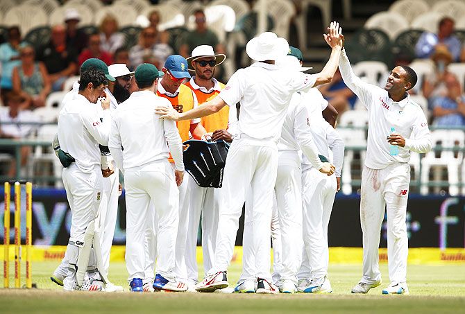South Africa's Dane Piedt celebrates taking the wicket of England's James Taylor