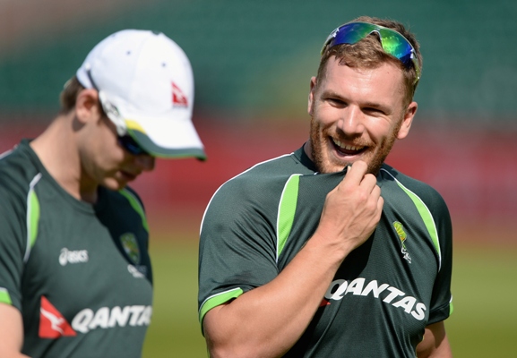 Aaron Finch of Australia chats with captain Steven Smith during a nets session 