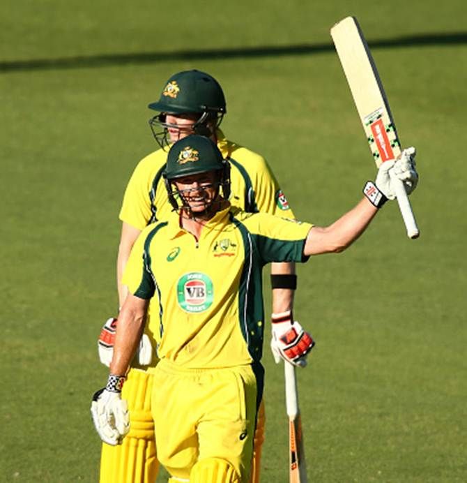 Australia's George Bailey celebrates after getting to hundred as his skipper, Steven Smith, watches in the first ODI against India in Perth on Tuesday.