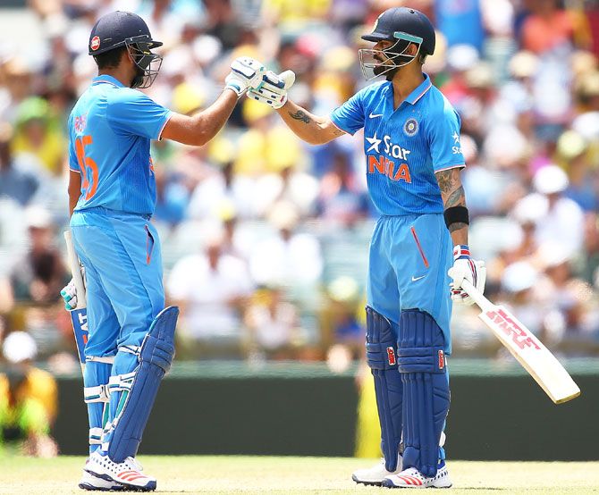 India's Rohit Sharma congratulates teammate Virat Kohli after reaching his half-century during the first One-Day International against Australia at the WACA in Perth on Tuesday