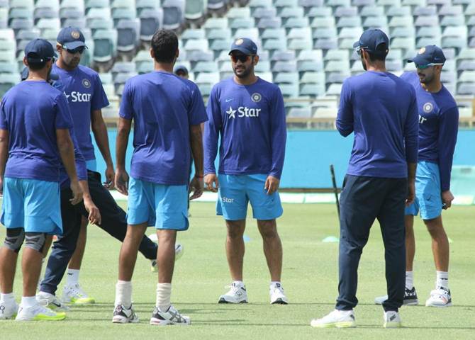 Mahendra Singh Dhoni, centre, addresses his players during a practice session 