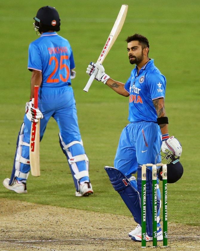 Virat Kohli celebrates after completing his century