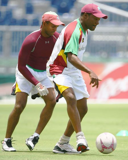 West Indies' Brian Lara plays football with teammate Shivnarine Chanderpaul during a team training session at the Kensington Oval on April 20, 2007 in Bridgetown, Barbados 