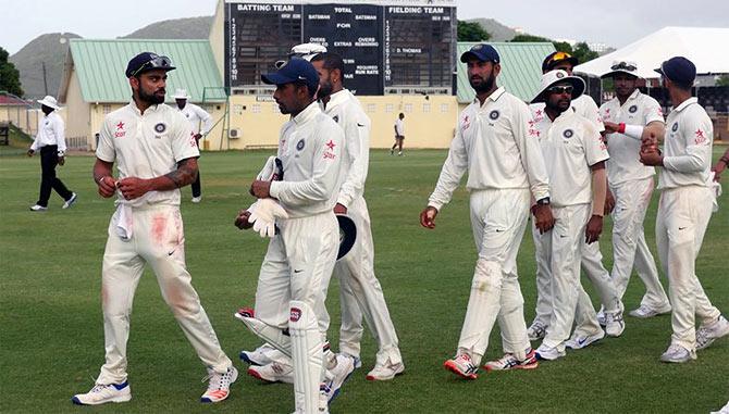 Captain Virat Kohli leads the Indian team off the field after the two-day practice game against the West Indies Board President's XI ended in a draw in St Kitts, July 10, 2016