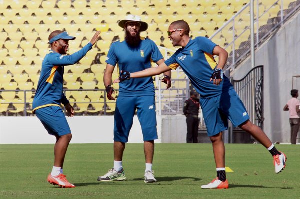 South African cricketer Hashim Amla and his teammates attend a practice session 
