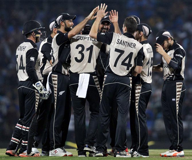 New Zealand's players celebrate the dismissal of India's Suresh Raina 