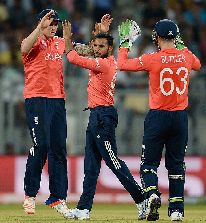 England's Adil Rashid celebrates with teammates Jason Roy and Jos Buttler after dismissing West Indies' Marlon Samuels on Wednesday
