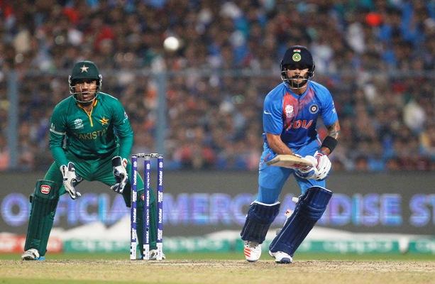 Virat Kohli's elegance watched by Pakistan's wicket-keeper Sarfraz Ahmed. Photograph: Rupak De Chowdhuri/Reuters