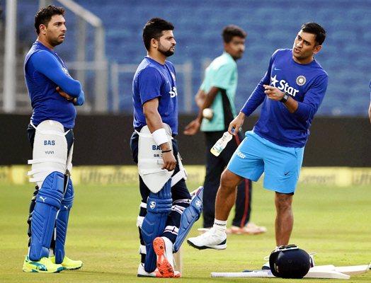 Indian team captain Mahendra Singh Dhoni along with teammates Yuvraj Singh and Suresh Raina during a practice session