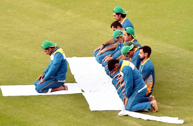 Pakistan's cricket players offer namaz after a training session at PCA Mohali on the eve of World Cup T20 match against New Zealand on Monday