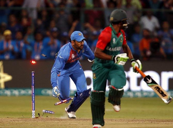 Mahendra Singh Dhoni runs out Mustafizur Rahman (not in picture) to seal victory for India in the ICC World T20 game against Bangladesh in Bengaluru, March 24, 2016. Photograph: Danish Siddiqui/Reuters