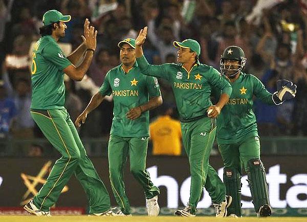 Pakistan players celebrate after a fall of a wicket