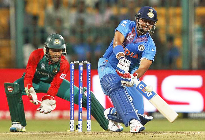 India's Suresh Raina (right) plays a shot