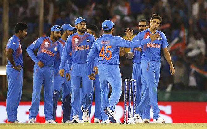  India's Ashish Nehra (right) is congratulated by teammates after taking the wicket of Australia's Usman Khawaja