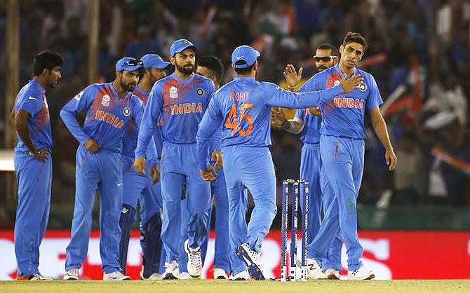 India's Ashish Nehra, right, is congratulated by teammates after taking a wicket
