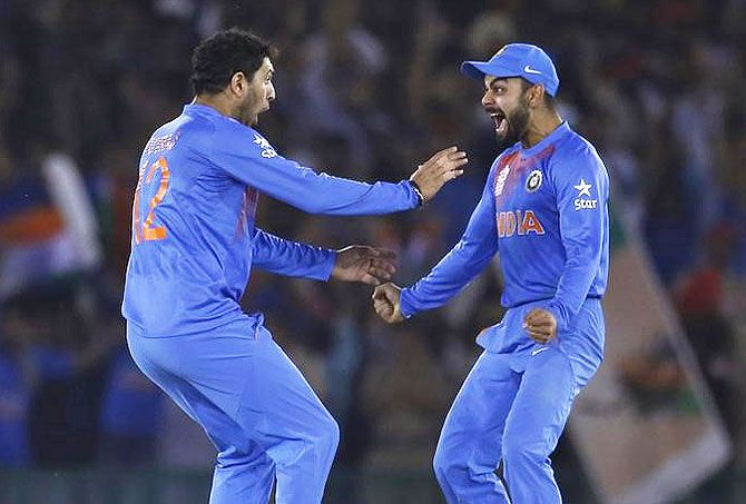 India's Yuvraj Singh (left) celebrates with his teammate Virat Kohli after taking the wicket of Australia's captain Steven Smith during their World T20 match in Mohali on Sunday