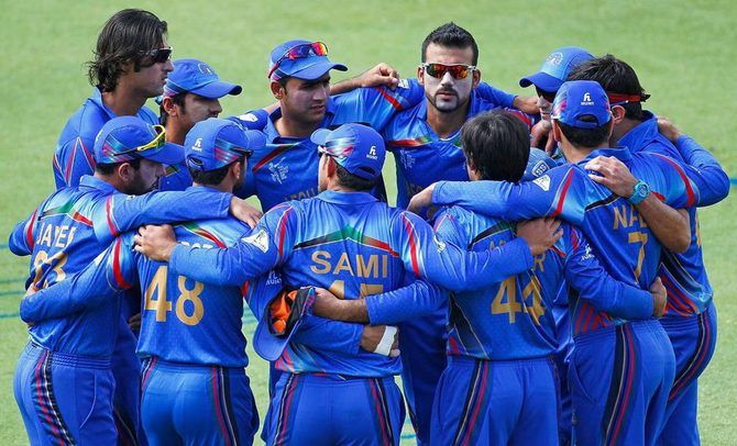 Afghanistan's players get into a huddle before the start of a match