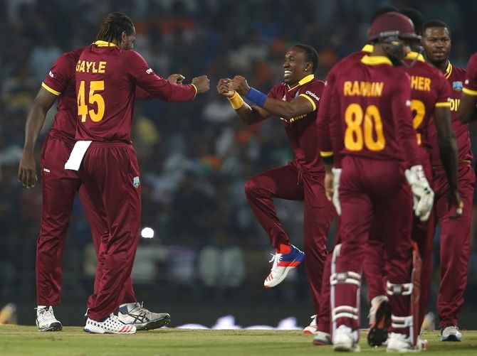 West Indies Chris Gayle (L) and Dwayne Bravo celebrate after Gayle took a wicket 