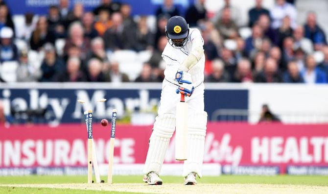 Sri Lanka's Nuwan Pradeep is bowled by James Anderson