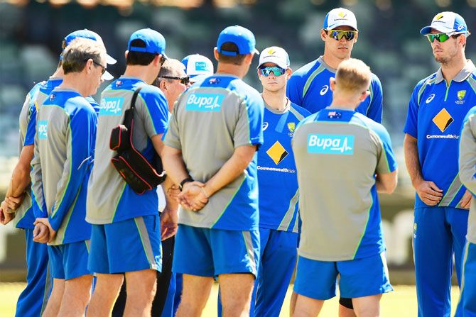 Steve Smith listens to a team address during an Australia nets session