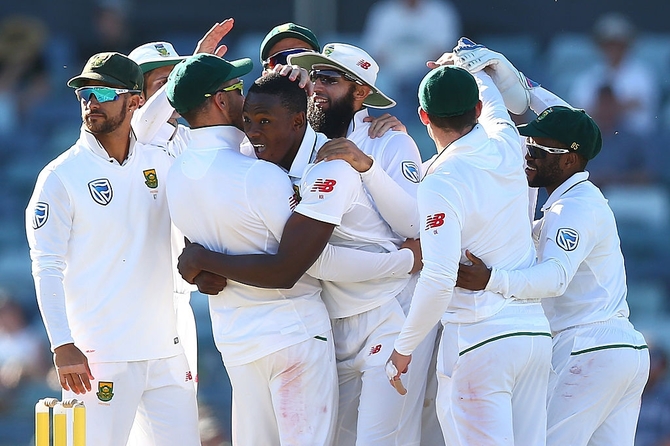 Kagiso Rabada of South Africa celebrates with team mates after dismissing Steve Smith of Australia