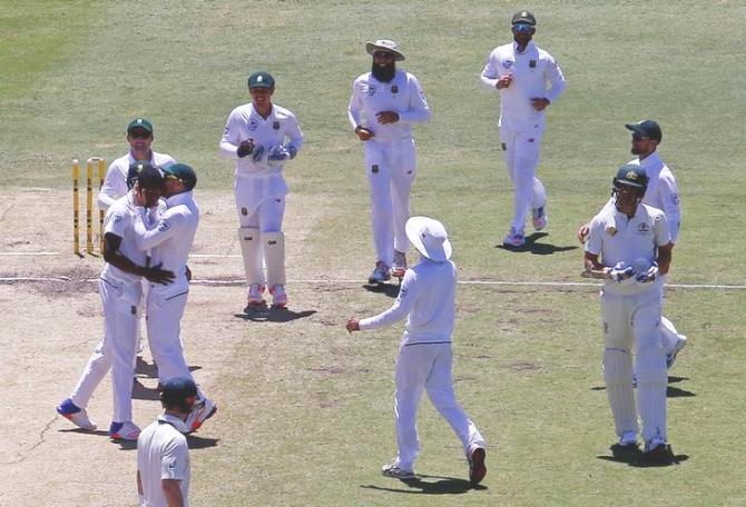 South Africa's Kagiso Rabada gets a kiss from captain, Faf du Plessis as they celebrate the dismissal of Australia's Mitchell Starc on Day 5 of the first Test at the WACA Ground in Perth on Monday