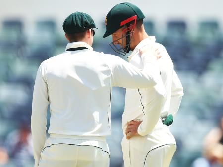 Australia captain Steve Smith checks on teammate Shaun Marsh after he was struck by the ball during Day 4's play during the first Test match against South Africa at the WACA in Perth on Sunday