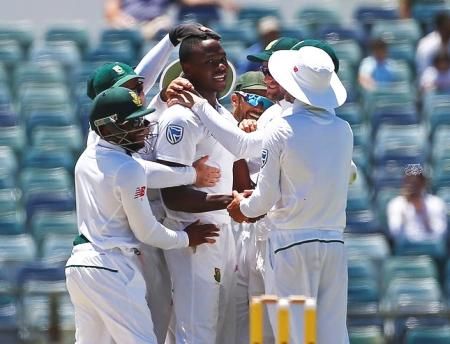 South Africa's Kagiso Rabada celebrates with team mates after dismissing Australia's Mitchell Starc at the WACA Ground in Perth on Monday