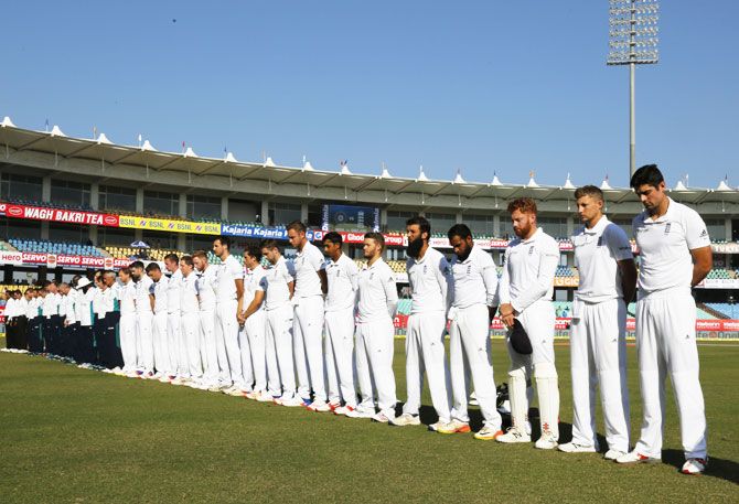 England players observe a minute's silence as they pay to homage to Armed Forces on Armistice Day before the start of play on Day 3 of the first Test against India at the Saurashtra Cricket Association Stadium in Rajkot on Friday