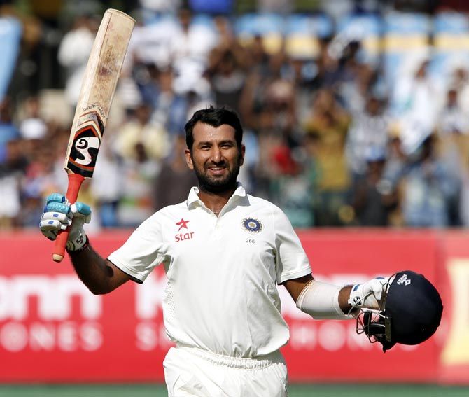 A delighted Cheteshwar Pujara after completing his century against England on his home ground in Rajkot. Photograph: BCCI