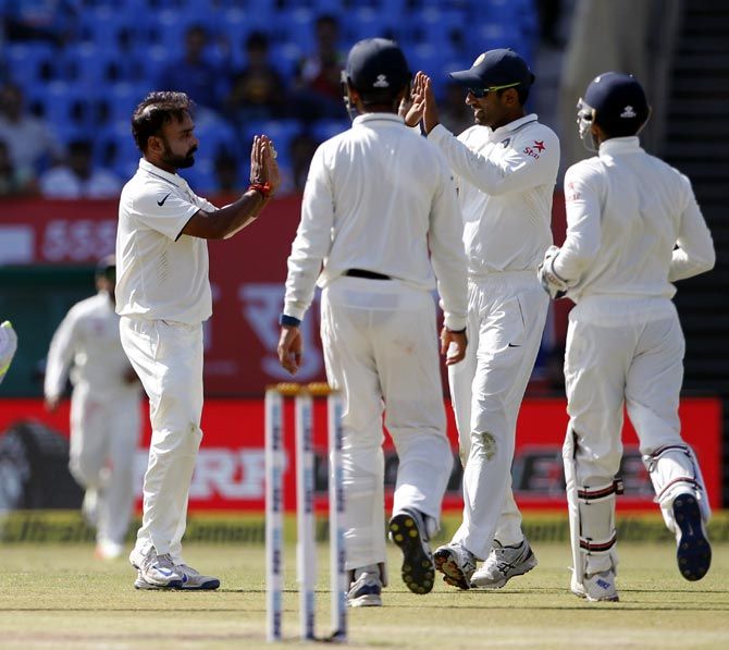 Amit Mishra, left, celebrates with team mates after taking the wicket of Haseeb Hameed