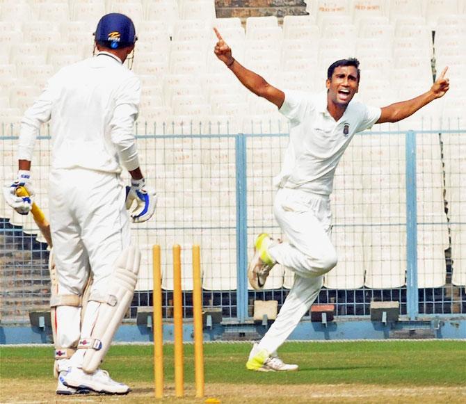 Maharashtra bowler Anupam Sanklecha celebrates after taking wicket of Vidarbha batsman Akshay Wakhare (left) during their Ranji Trophy match at Eden Gardens in Kolkata on Tuesday