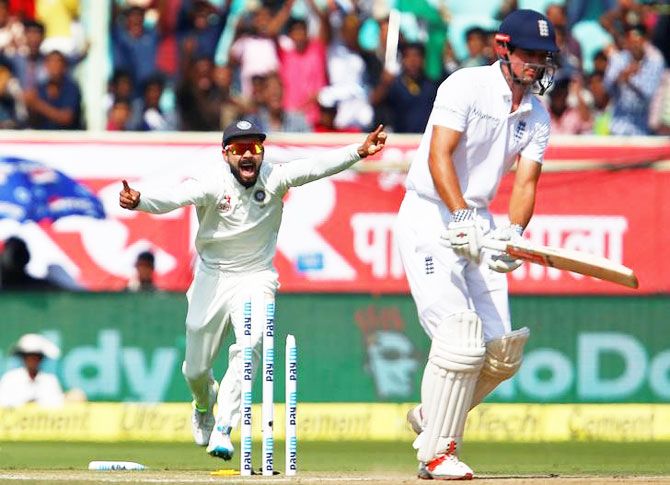 India captain Virat Kohli (left) celebrates the dismissal of England's Alastair Cook on Friday