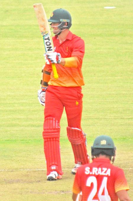 Zimbabwe's Craig Ervine celebrates on completing his half-century