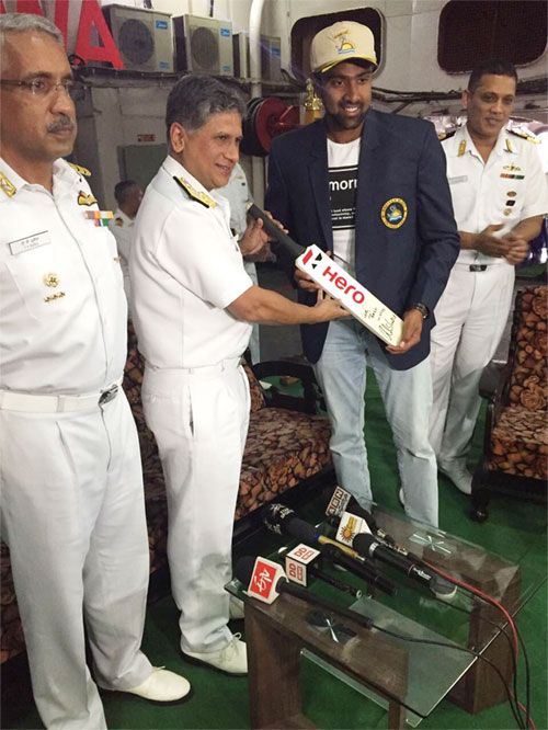 India cricketer R Ashwin (right) presents an autographed bat to Rear Admiral Dasgupta on board INS Jalashwa on Monday