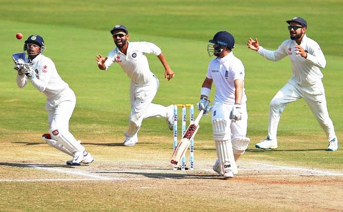 India's Wriddhiman Saha (left) takes a catch to dismiss England's Ben Duckett on Day 5 of the 2nd Test in Vizag on Monday